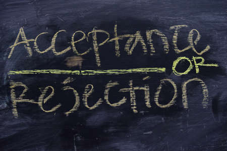 Acceptance or Rejection written with color chalk concept on the blackboardの写真素材