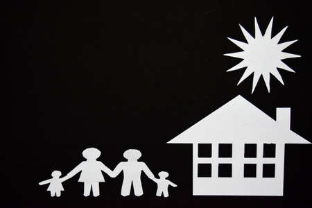 concept image of make your a house. Paper cut of family with house and treeの写真素材