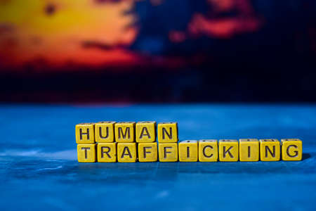 Human trafficking on wooden blocks. Cross processed image with bokeh backgroundの写真素材