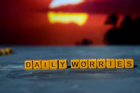 Daily worries on wooden blocks. Cross processed image with bokeh backgroundの写真素材