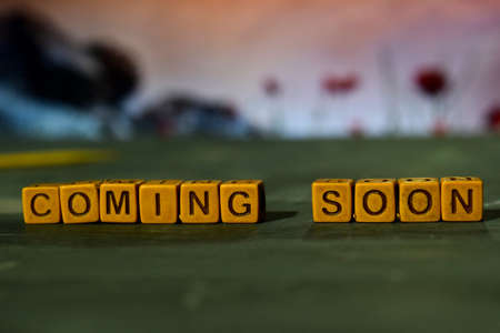 Coming soon on wooden blocks. Cross processed image with bokeh backgroundの写真素材