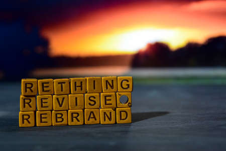Rethink - Revise - Rebrand on wooden blocks. Cross processed image with bokeh backgroundの写真素材