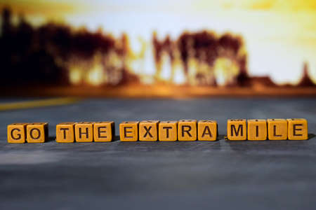 Go the extra mile on wooden blocks. Cross processed image with bokeh backgroundの写真素材