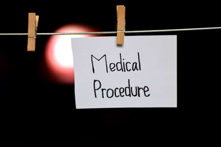 Medical Procedure handwriting on paper. Hanged with a clothes clips, medical and education concept. light blur backgroundの写真素材