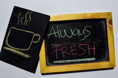 Drawing cup of coffee and Always FRESH on phrase colorful handwritten on blackboard white background. Education conceptの写真素材