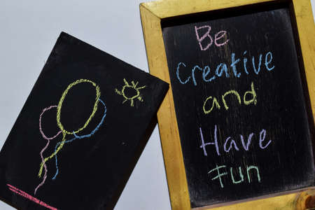 Be Creative and Have Fun on phrase colorful handwritten on blackboard with balloon and sun, white background. Education conceptの写真素材