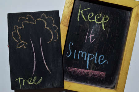 Keep it Simpe on phrase colorful handwritten on blackboard, tree with white background. Education...