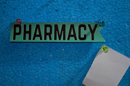 Pharmacy text on the paper is attached to the foam with push pins, Health care concept as a schedule remindersの写真素材