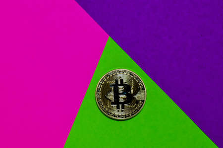 Bitcoin Gold on pink, purple and green colorful background. Business and finance conceptの写真素材