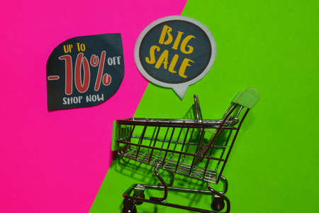 Up To -70% Off Shop Now and Big Sale Text and Shopping cart. Discount and promotion business concept on colorful backgroundの写真素材