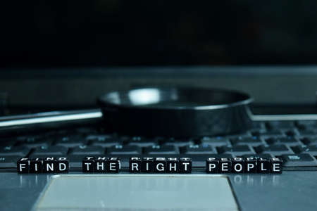 Find the Right People text wooden blocks in laptop background. Business and technology conceptの写真素材
