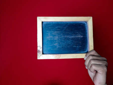 Chalkboard and hands on the red background
