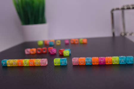 Personal Vs Political on wooden blocks. Cross processed image with business concept on White backgroundの写真素材