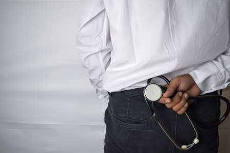 Physician or doctor holding stethoscope. Listening story patient concept. Selective focus in pants....