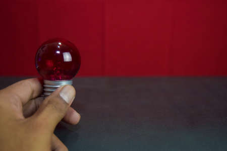 Close up lamp in red background and black table