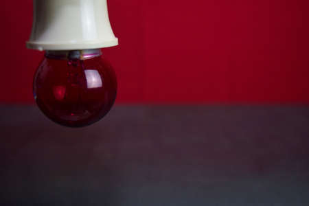 Close up lamp in red background and black tableの写真素材