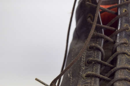 Close up of a brown old boots isolated on white backgroundの写真素材