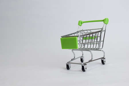Close up shopping cart, shopping trolley isolated on white backgroundの写真素材