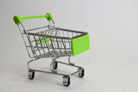 Close up shopping cart, shopping trolley isolated on white backgroundの写真素材