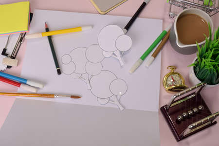 Top view of the cutting paper illustration a trees on a pink table, preparing to do homework in a clipboard. Drawing Working Desk Conceptの写真素材
