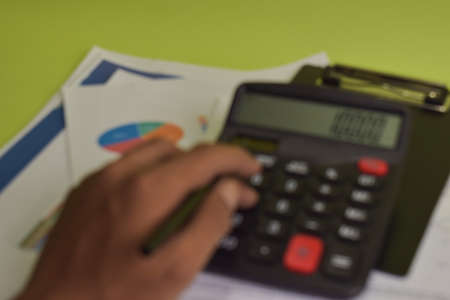 Blur and defocused calculate about cost and doing finance at home office. Business and Finance...