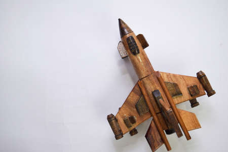 Close up vintage wooden airplane toy made from bamboo. Isolated on a white background.の写真素材