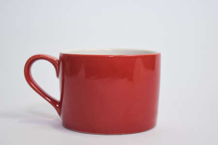 Close up hot cappuccino coffee in a red cup isolated on a white background