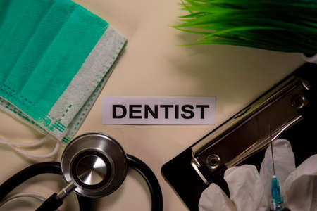 DENTIST with inspiration and healthcare/medical concept on desk backgroundの写真素材