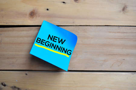 New Beginning text on sticky notes with wooden backgroundの写真素材