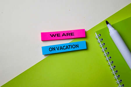 We Are on Vacation text on top view office desk table of Business workplace and business objects.の写真素材