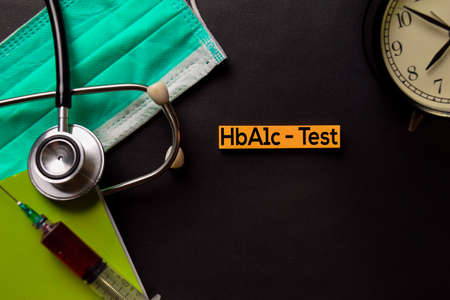 HbA1c - Test text on top view black table with blood sample and Healthcare/medical concept.の写真素材