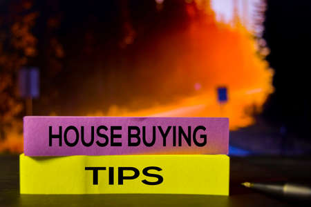 House Buying Tips on the sticky notes with bokeh background