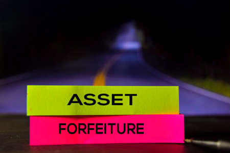 Asset Forfeiture on the sticky notes with bokeh background
