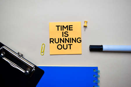 Time Is Running Out text on sticky notes with office desk conceptの写真素材