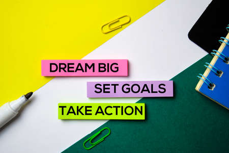 Dream Big. Set Goals. Take Action text on sticky notes with office desk conceptの写真素材