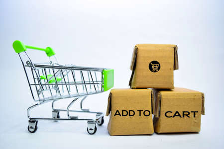 Add To Cart Text in small boxes and shopping cart. Concepts about online shopping. Isolated on white backgroundの写真素材