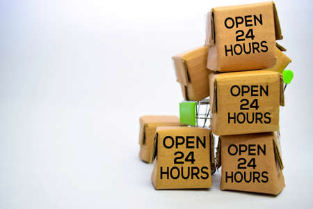 Open 24 Hours Text in small boxes and shopping cart. Concepts about online shopping. Isolated on white backgroundの写真素材