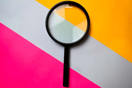Magnifying glass isolated on color backgroundの写真素材