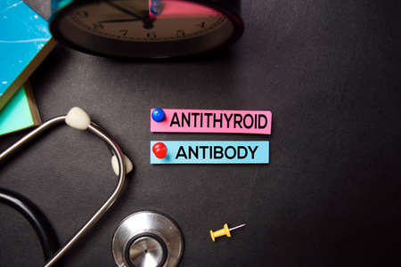Antithyroid Antibody text on Sticky Notes. Top view isolated on black background. Healthcare/Medical...