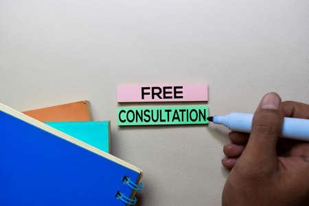 Free Consultation text on sticky notes isolated on office deskの写真素材