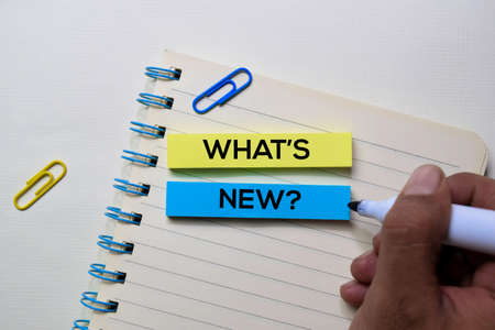 What's New? text on sticky notes isolated on office desk