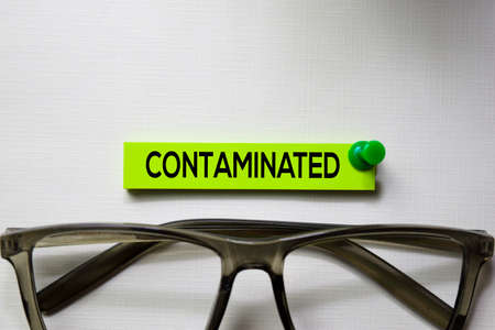 Contaminated text on sticky notes isolated on office deskの写真素材