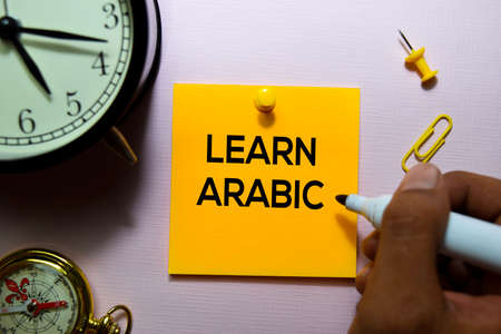 Learn Arabic text on sticky notes isolated on office desk