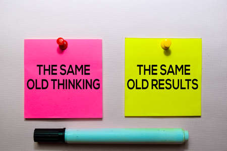 The Same Old Thinking and The Same Old Results text on sticky notes isolated on office deskの写真素材