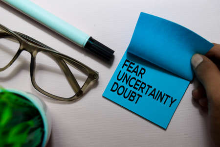 Fear Uncertainty Doubt (FUD) text on sticky notes isolated on office deskの写真素材