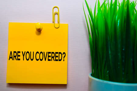 Are You Covered? text on sticky notes isolated on office deskの写真素材