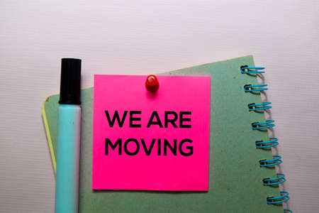 We Are Moving text on sticky notes isolated on office desk