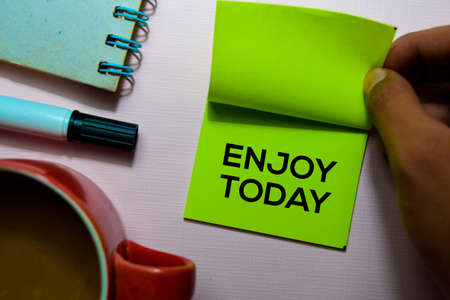 Enjoy Today text on sticky notes isolated on office deskの写真素材