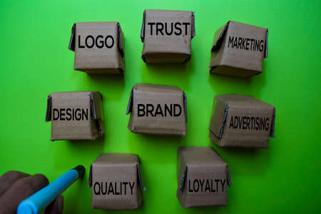 Brand, Design, Logo, Trust, Marketing, Advertising, Loyalty, Quality text on box isolated on green...