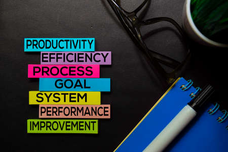 Productivity, Efficiency, Process, Goal, System, Performance, Improvement text on sticky notes isolated on Black desk. Mechanism Strategy Conceptの写真素材